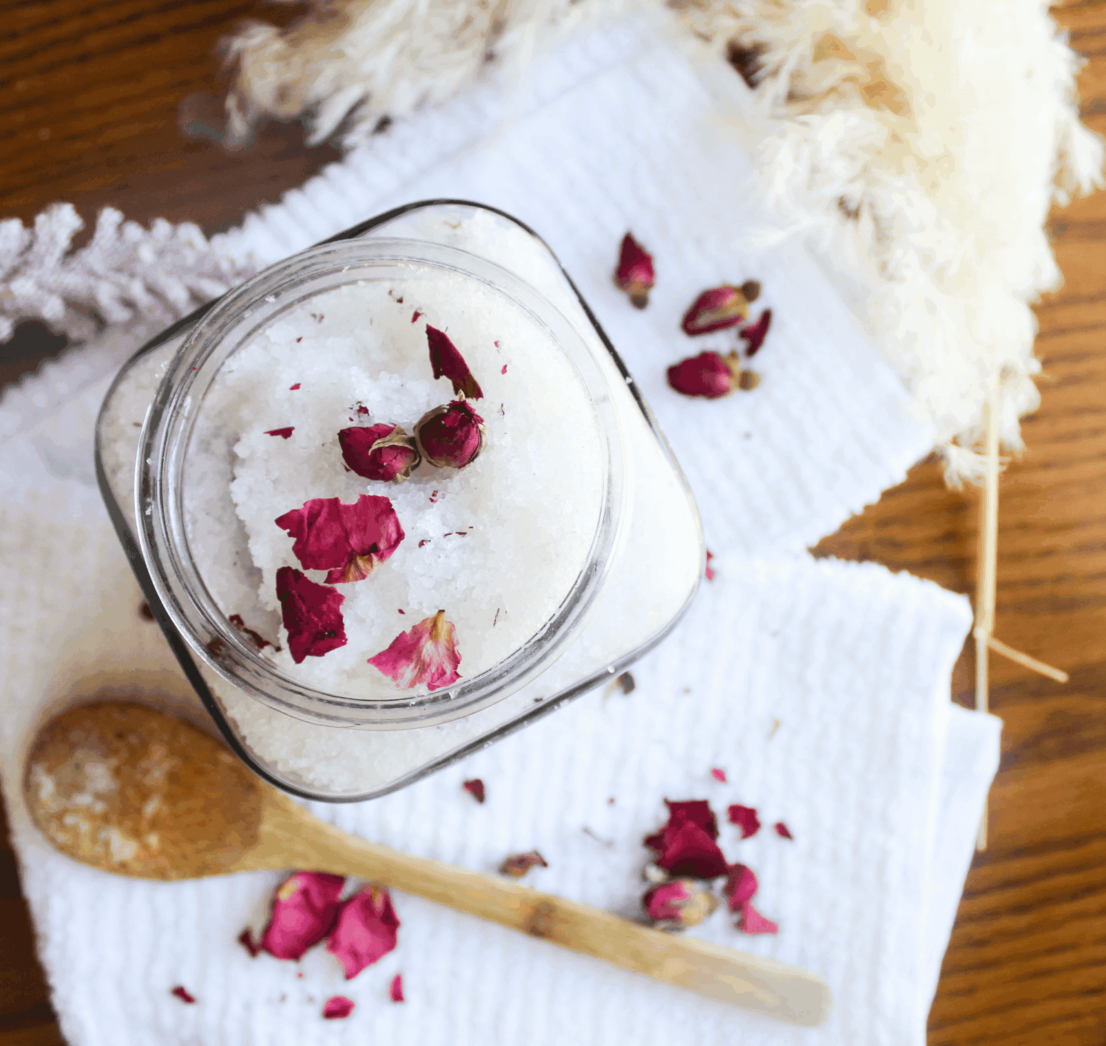 DIY Bath Salts for Muscle Relief and Relaxation (with Lavender & Epsom Salt) Glass jar filled with lavender rose bath salts topped with dried rose petals
