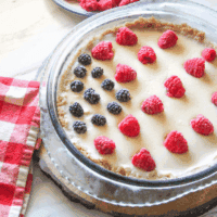 Close-up of fresh blackberries and raspberries on creamy 4th of July Pie