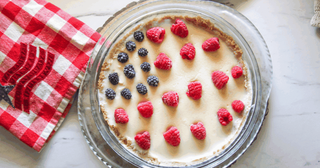 4th of July Pie on table with fresh berries, ready to serve