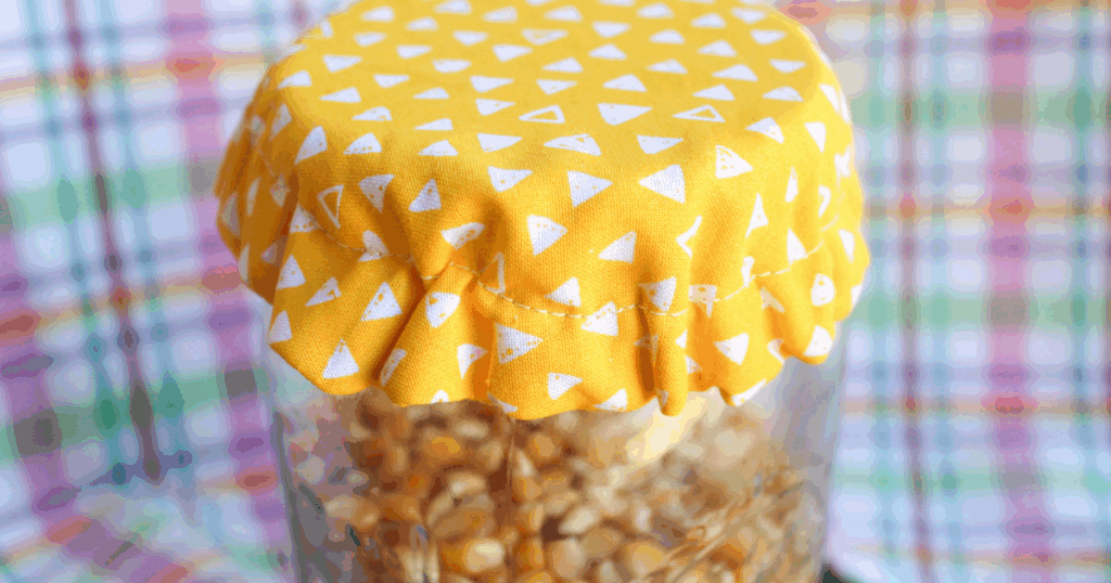 Side view of the finished jar cover showing soft fabric edges and clean seams.