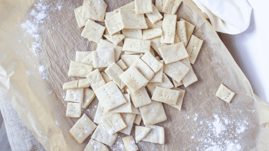 Homemade sourdough discard crackers stacked on a wooden surface
