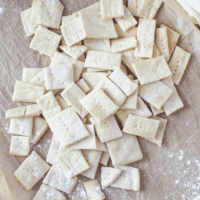 Sourdough Discard Crackers Homemade sourdough discard crackers stacked on a wooden surface