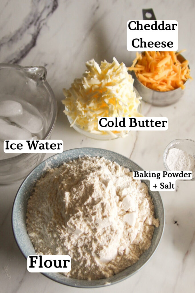 cheddar biscuits ingredients laid out on a white kitchen counter.