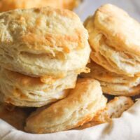 Easy Cheddar Biscuits Three cheddar biscuits stacked on top of each other to show height and fluffiness.
