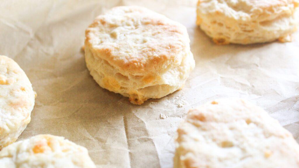 Easy Cheddar Biscuits Overhead view of cheddar biscuits arranged on a plate or board.