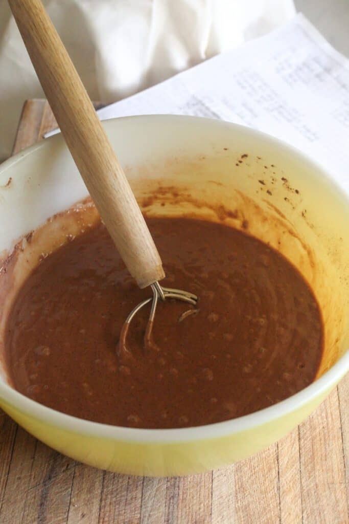Smooth chocolate cake batter mixed in a large bowl, ready for pouring.