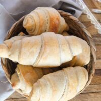 Golden flaky sourdough crescent rolls fresh from the oven
