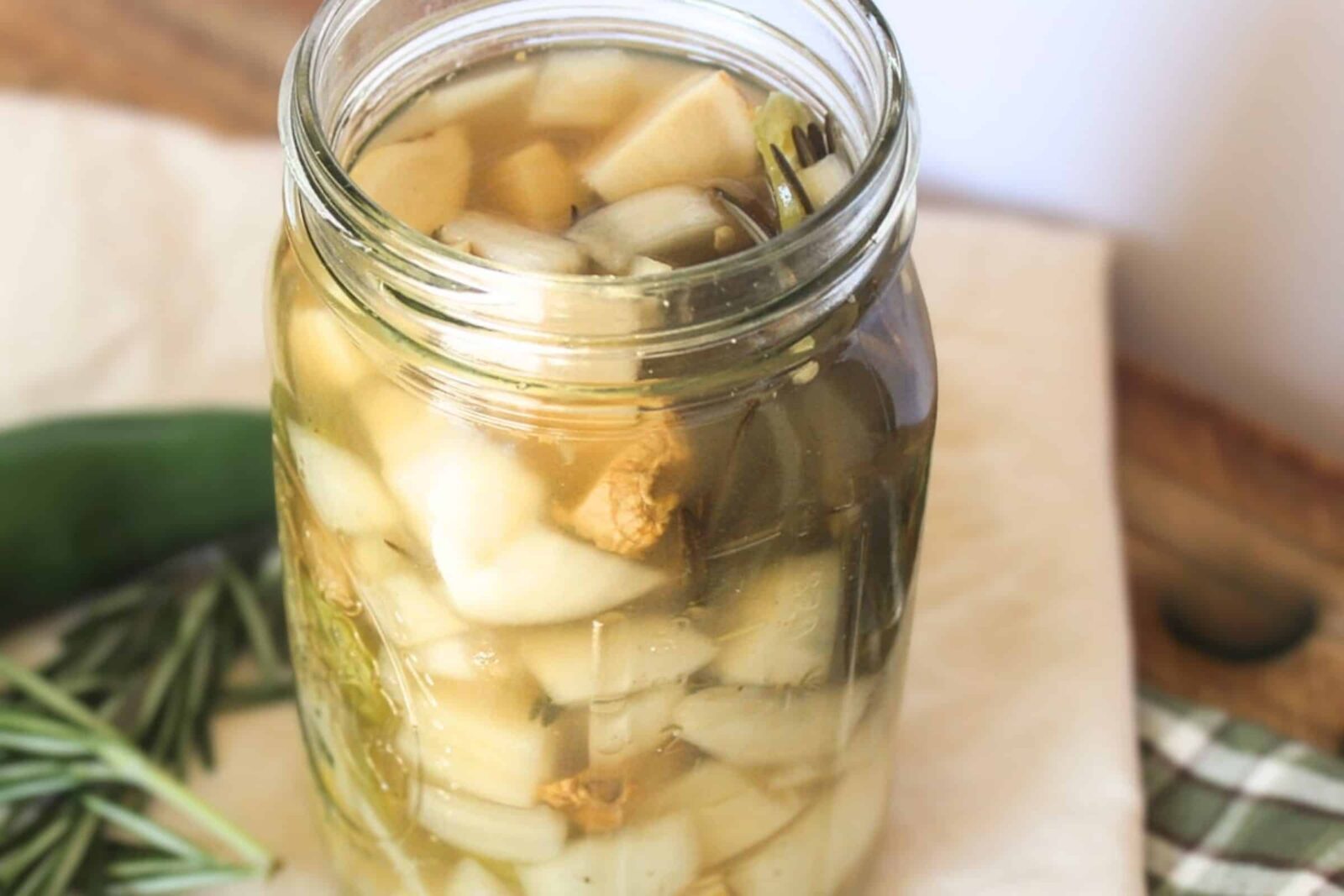 Fire Cider Recipe Homemade fire cider recipe in a glass jar with fresh ginger, garlic, and jalapeño.