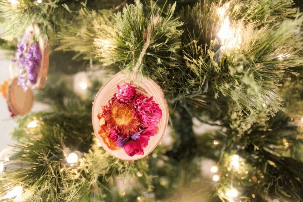 Wood slice Christmas ornaments decorated with dried flowers, rustic holiday decor