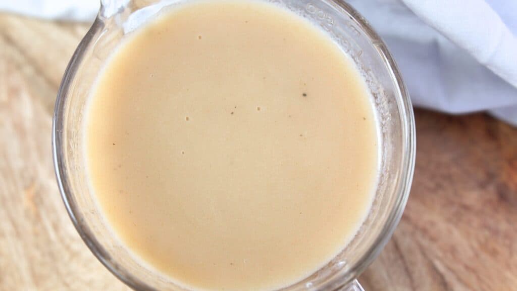 Bone Broth Gravy Smooth and creamy bone broth gravy in a glass measuring cup.
