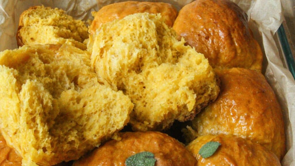 Fluffy pumpkin roll torn open to show the texture.