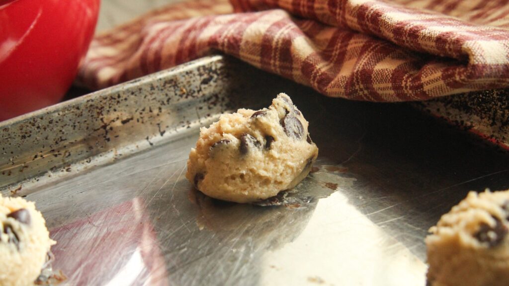 Scooped Greek yogurt chocolate chip cookie dough on a baking tray