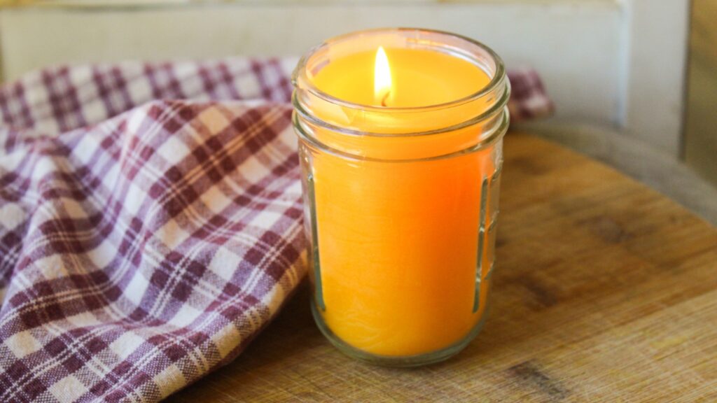 Hand-poured beeswax candles glowing softly in a cozy natural home setting.
