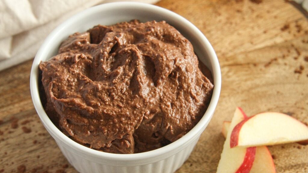 Vegan chocolate hummus served with fresh apple slices