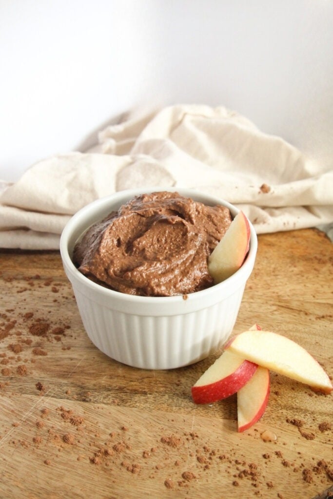 Vegan chocolate hummus dip with fresh apples for dessert