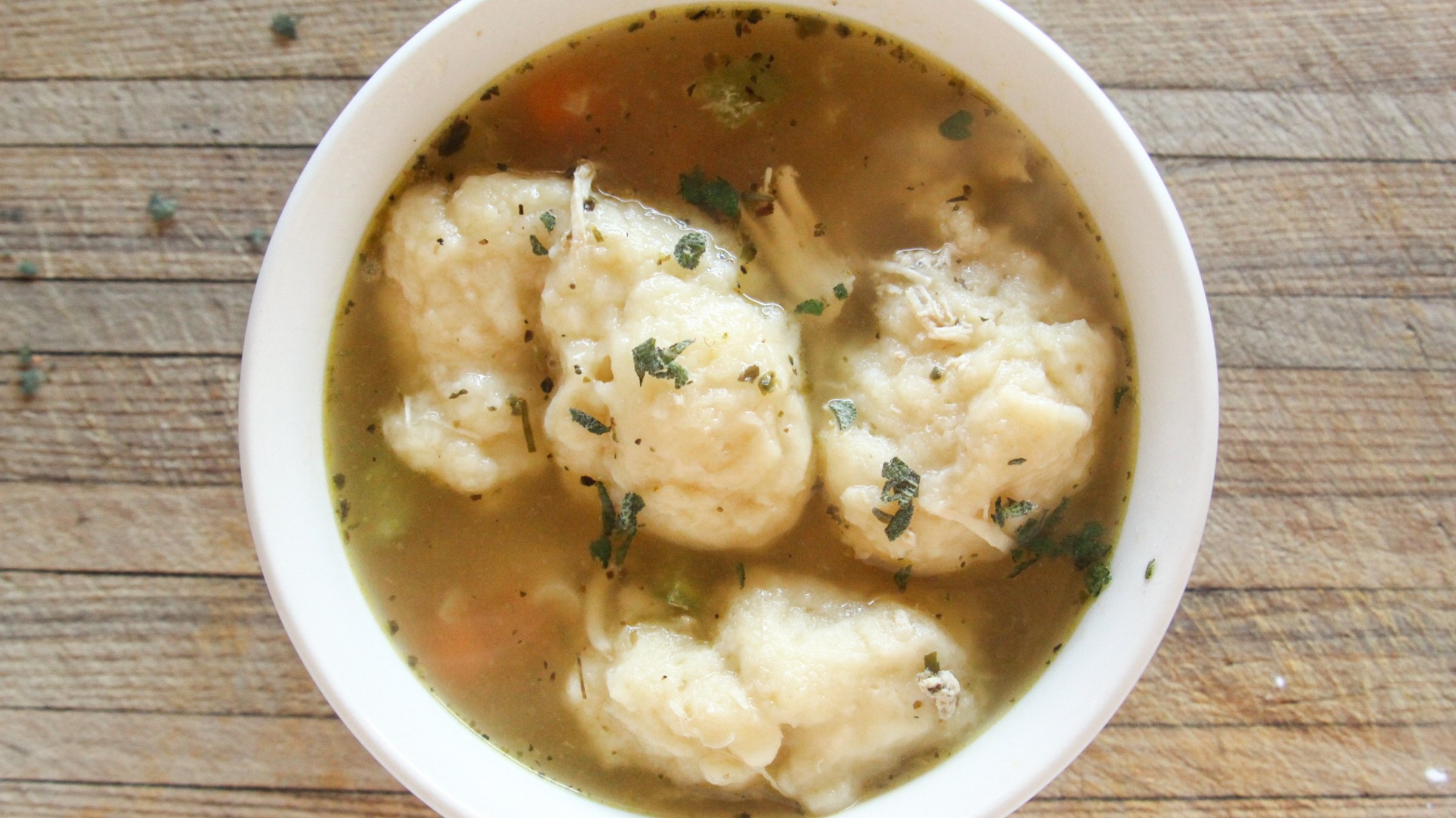 Hot, cooked healthy chicken and dumplings soup in a bowl
