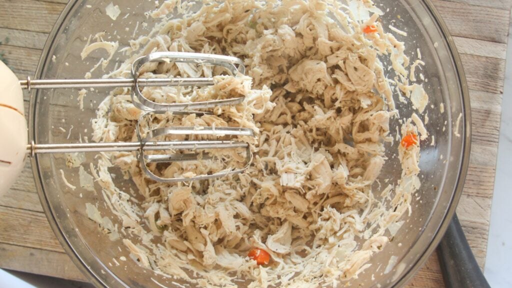 Shredded chicken in a bowl for healthy chicken and dumplings recipe