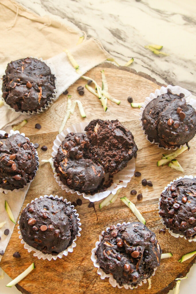 Chocolate Chip Zucchini Muffins Chocolate zucchini muffin broken open to show moist crumb