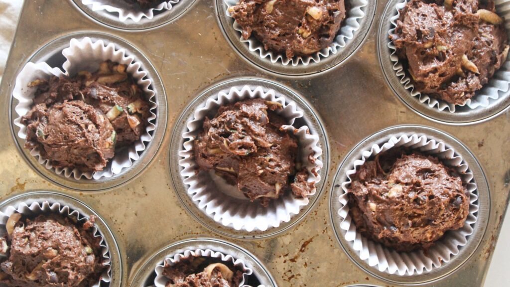 Chocolate Chip Zucchini Muffins Unbaked chocolate zucchini muffins filled in a muffin pan