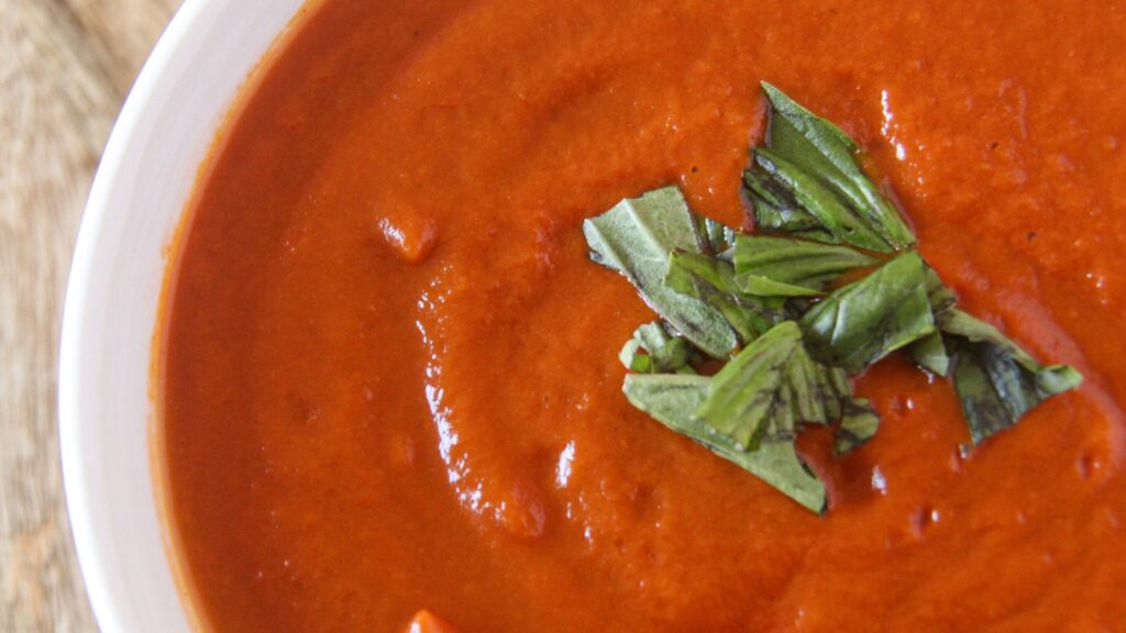 Hidden veggie pasta sauce in a bowl with fresh basil