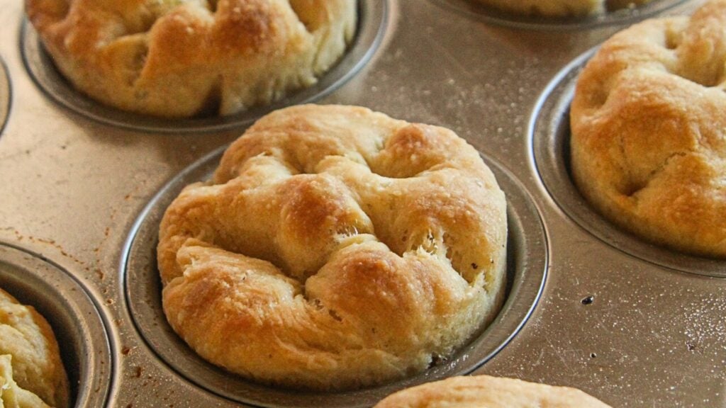 Close-up of a no-yeast focaccia muffin with olive oil and sage