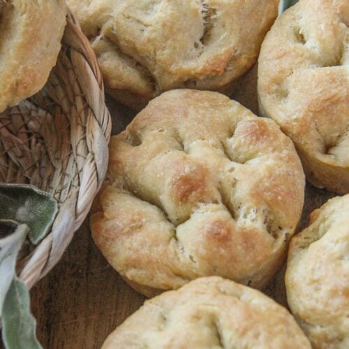 No-yeast focaccia muffins with fresh sage on a cutting board
