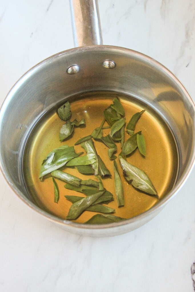Sage leaves steeping in olive oil for focaccia muffins
