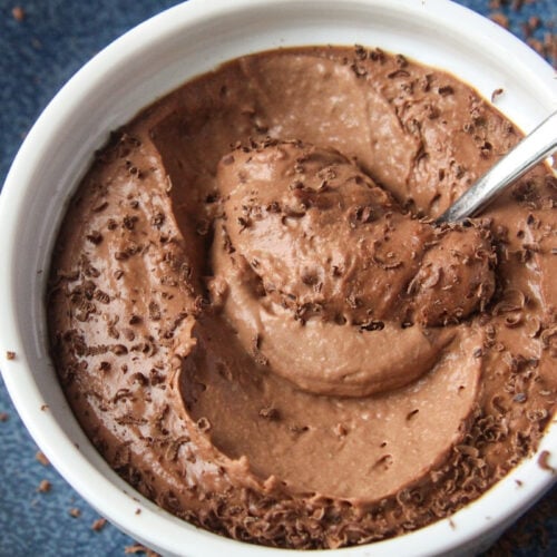 Healthy cauliflower chocolate mousse in a small ramekin, close-up view