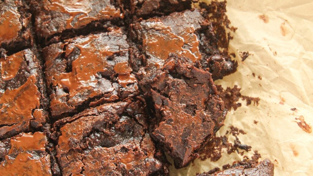Sweet potato brownies cut into squares on parchment paper