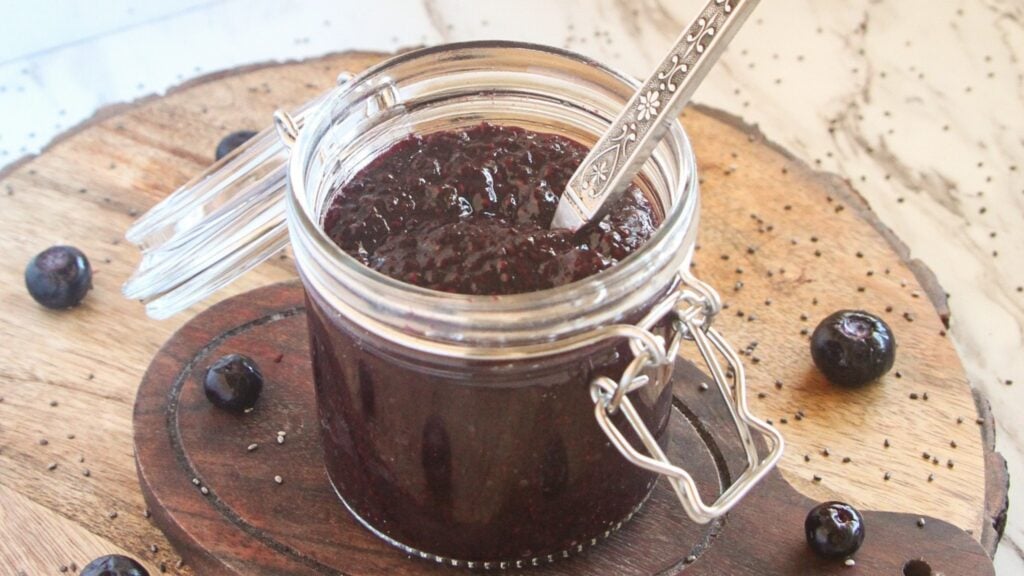 Best blueberry chia jam recipe in vintage glass jar with spoon